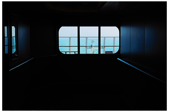 This picture belongs to the series "the coast". It shows the view from the darkness of a ship to the sea.