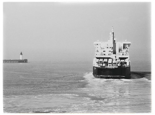 This picture belongs to the series "the coast". On the left of the picture a ferry leaving the harbor, on the right a lighthouse.